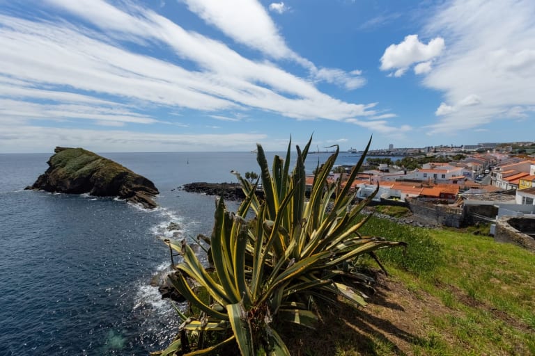 Vista costera de San Roque con acantilado, vegetación y pueblo junto al mar